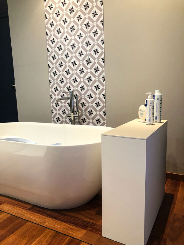 Création complète d’une salle de bain avec meuble laqué taupe. Sol en teck massif et baignoire à poser design